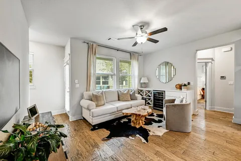a living room with furniture fireplace and a large window