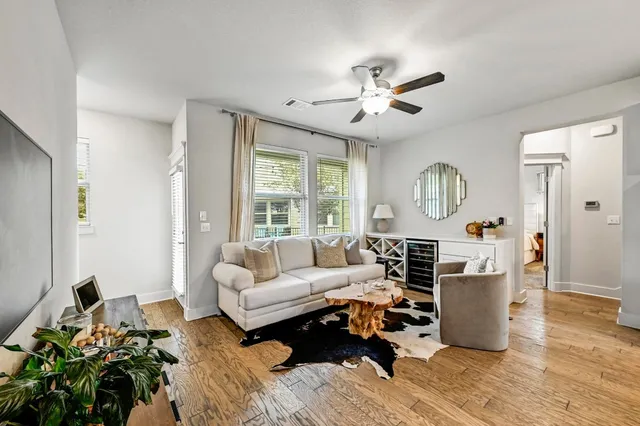 a living room with furniture fireplace and a large window