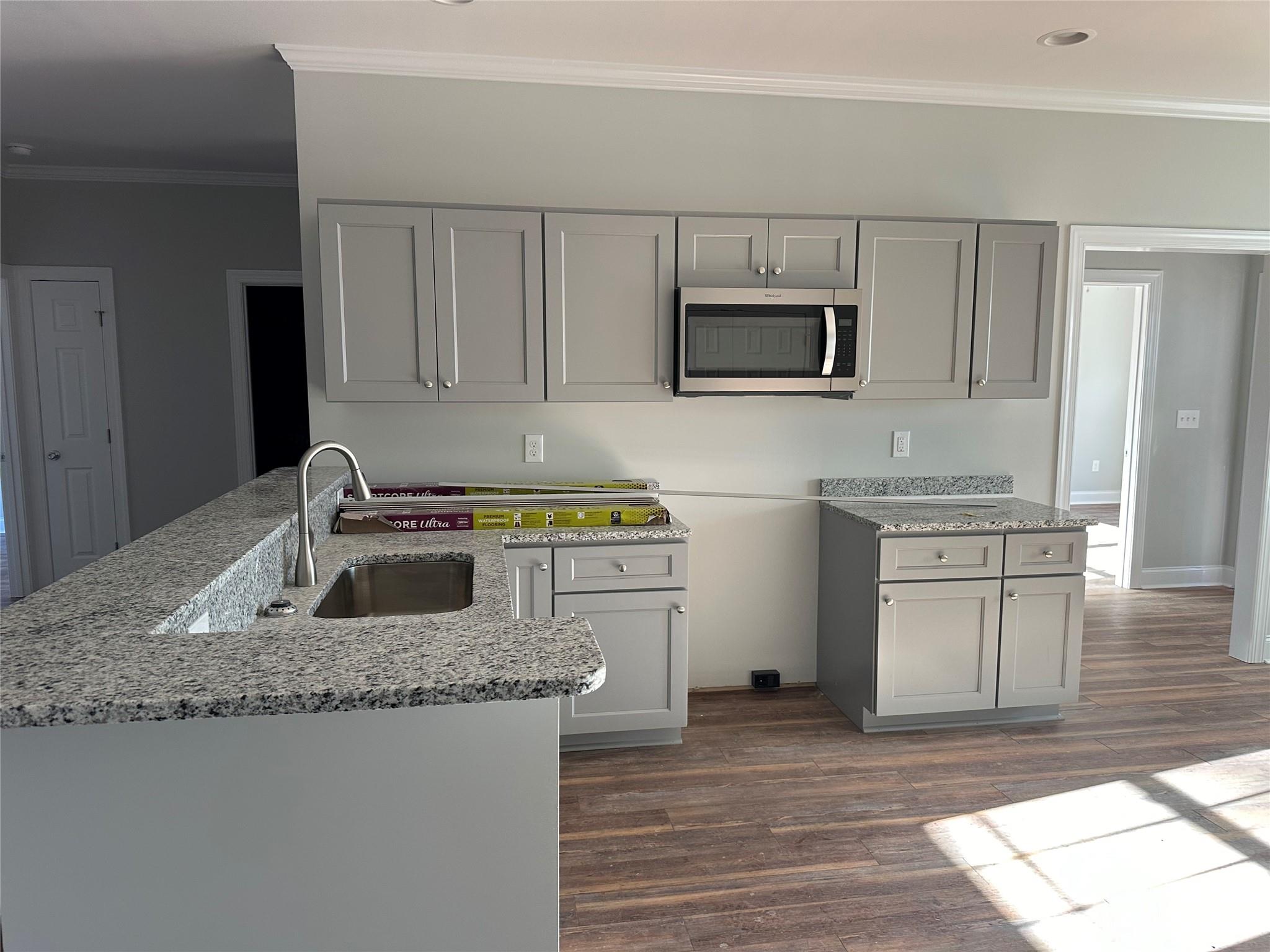 3807 Red Doc Road Lancaster, SC 29720 - Photo 3 of 7 a kitchen with stainless steel appliances granite countertop a sink stove and microwave