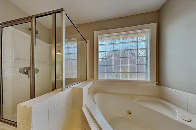 a bathroom with a bathtub and shower