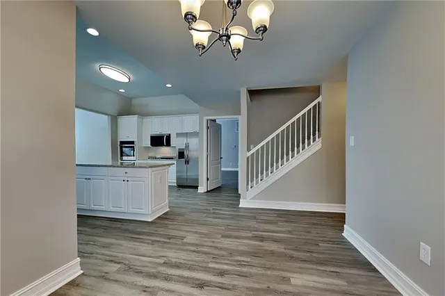 a view of kitchen with sink microwave and cabinets