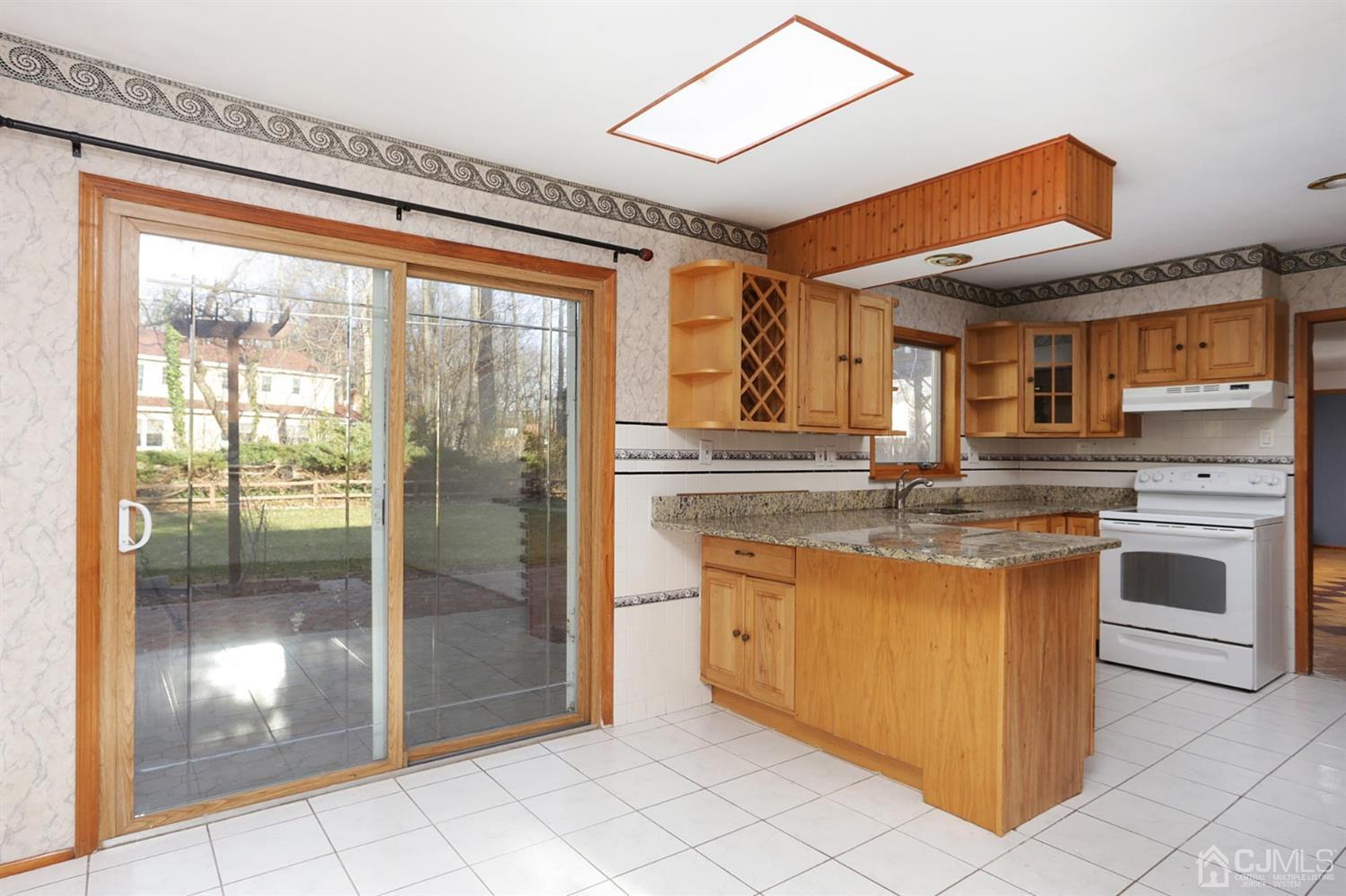 75 Lakeridge Drive Old Bridge, NJ 07747 - Photo 11 of 26 a kitchen with stainless steel appliances granite countertop a stove a sink and a refrigerator
