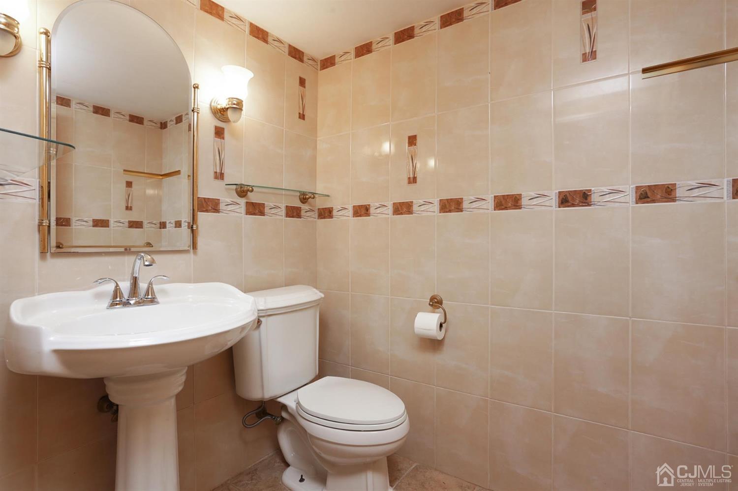 75 Lakeridge Drive Old Bridge, NJ 07747 - Photo 18 of 26 a bathroom with a sink a toilet and mirror