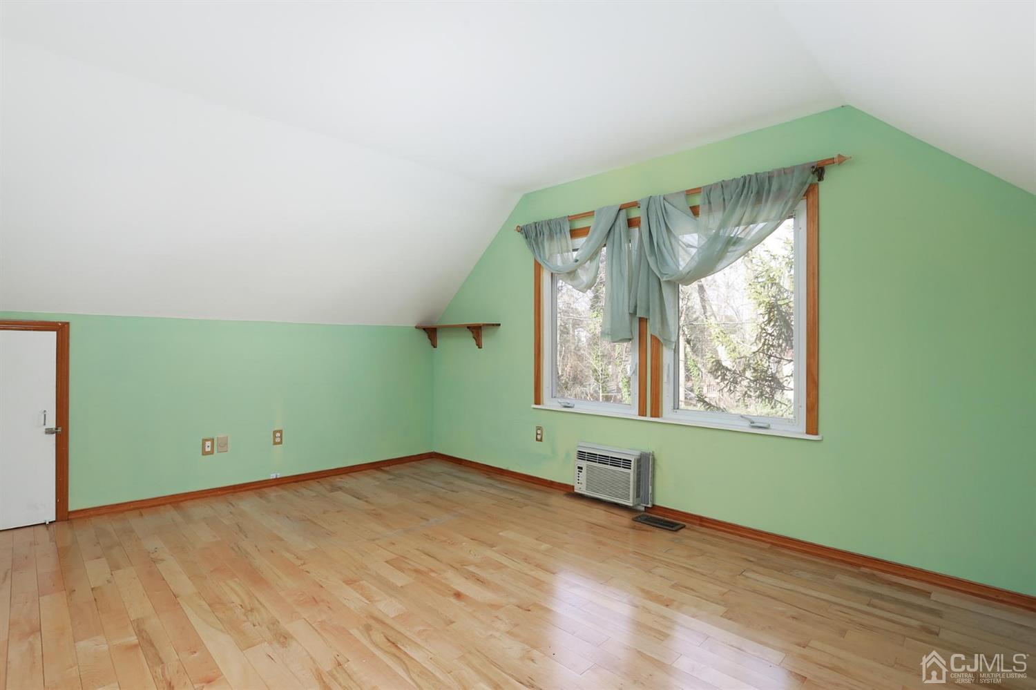 75 Lakeridge Drive Old Bridge, NJ 07747 - Photo 19 of 26 an empty room with wooden floor and a window