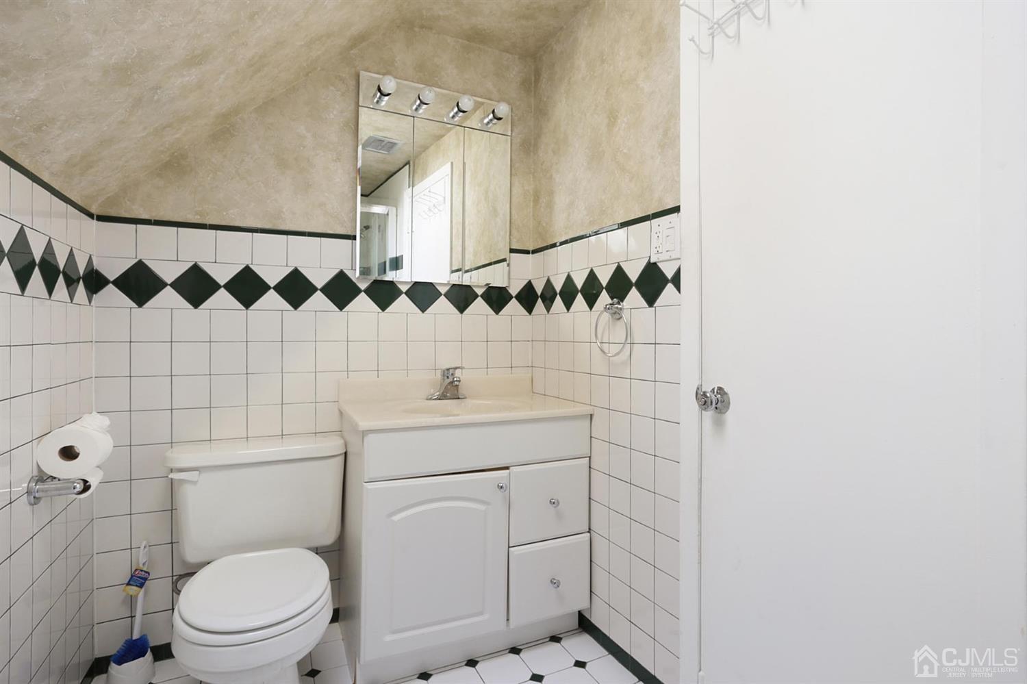 75 Lakeridge Drive Old Bridge, NJ 07747 - Photo 20 of 26 a bathroom with a sink a toilet and a mirror