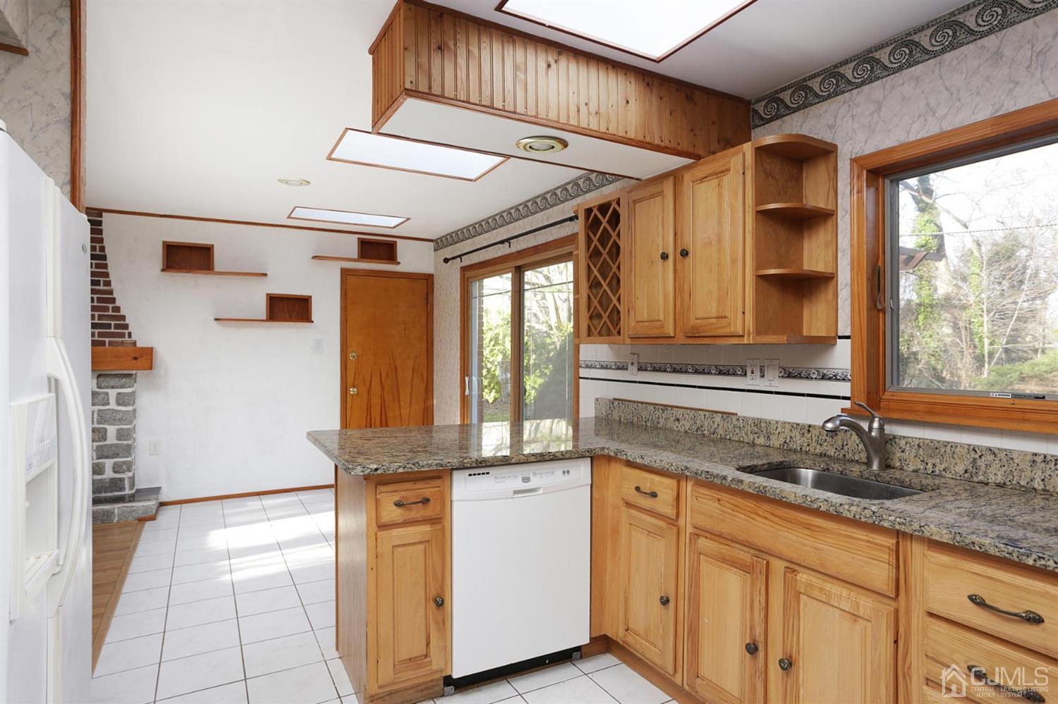 75 Lakeridge Drive Old Bridge, NJ 07747 - Photo 10 of 26 a kitchen with stainless steel appliances granite countertop a sink and a refrigerator