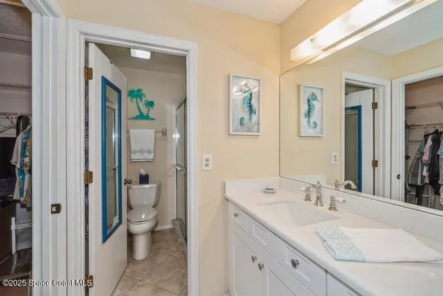 a spacious bathroom with a granite countertop sink toilet and shower
