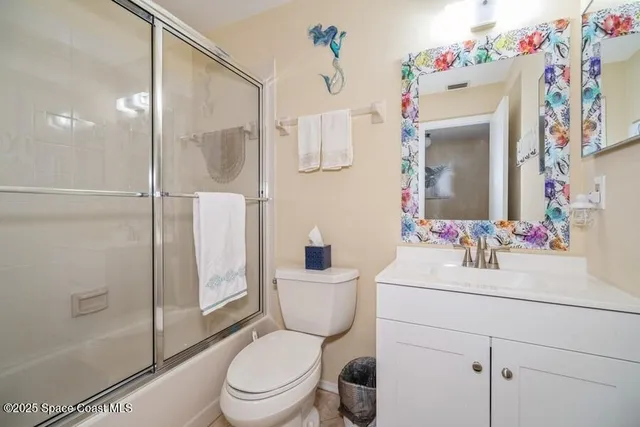 a bathroom with a sink toilet vanity and shower