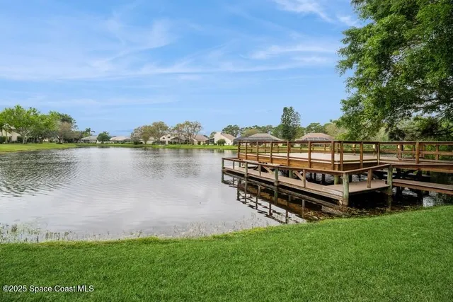 a view of a lake with houses in the background