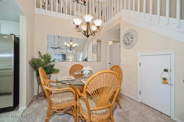a view of a dining room with furniture and a chandelier