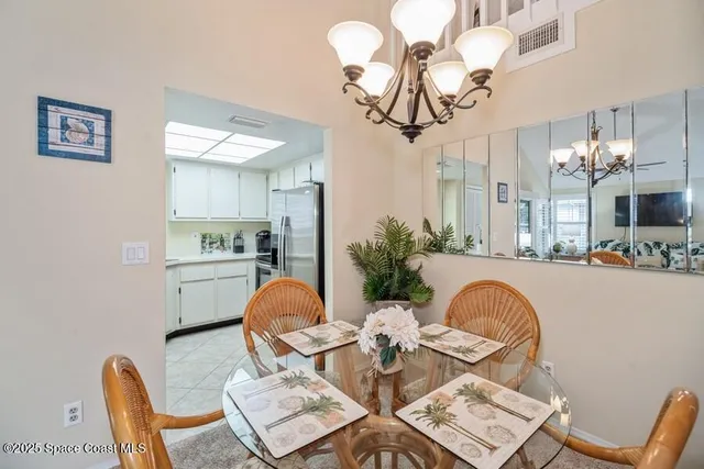 a view of a dining room with furniture and chandelier