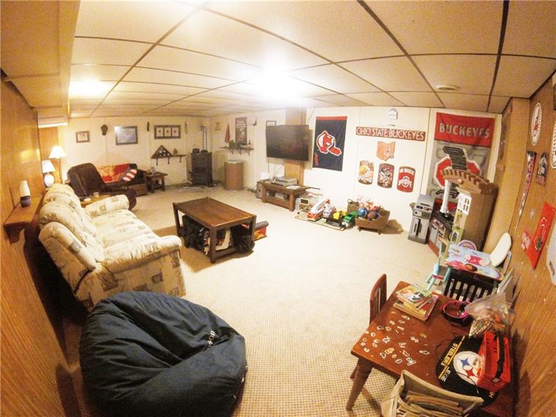 1153 Mercer Road Beaver Falls, PA 15010 - Photo 14 of 25 The finished basement is ready for football games in your man cave or an out-of-the-way place for the kids...