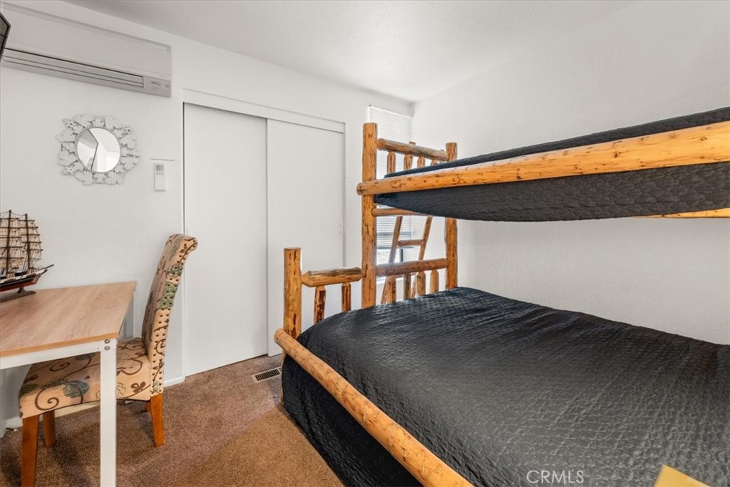 760 Bluejay Road, Unit 1 Big Bear Lake, CA 92315 - Photo 13 of 29 a bedroom with a bed and a desk