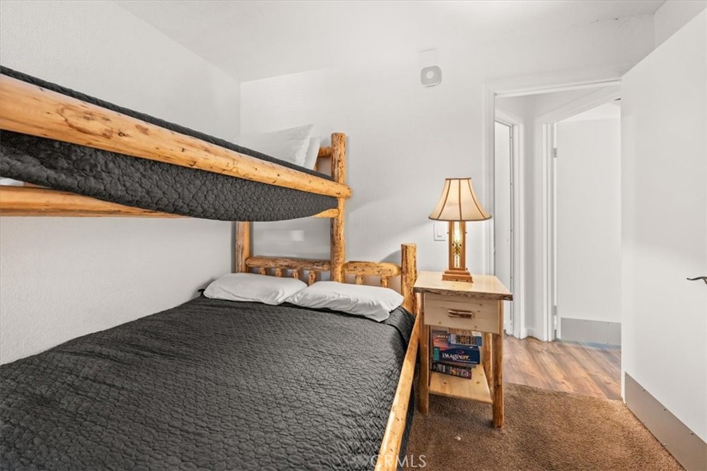 760 Bluejay Road, Unit 1 Big Bear Lake, CA 92315 - Photo 14 of 29 a bedroom with a bed and a table