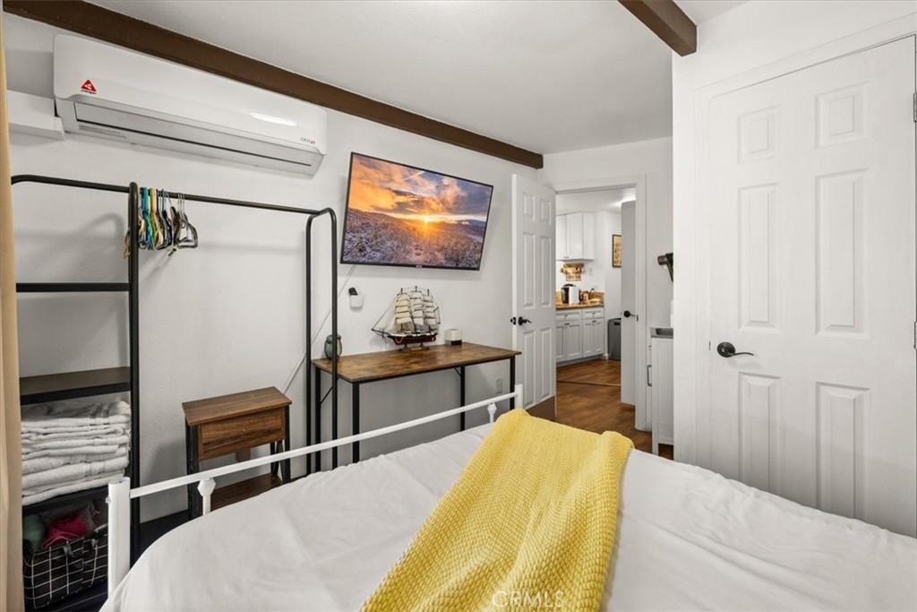 760 Bluejay Road, Unit 1 Big Bear Lake, CA 92315 - Photo 18 of 29 a bedroom with a bed and a flat screen tv