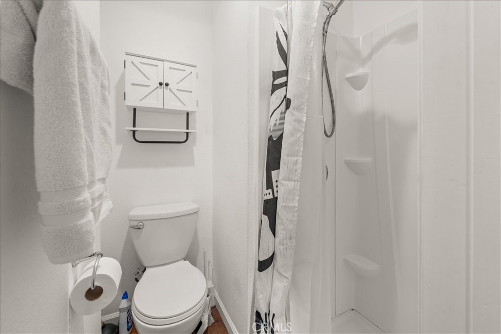 760 Bluejay Road, Unit 1 Big Bear Lake, CA 92315 - Photo 21 of 29 a white toilet sitting next to a bathroom sink