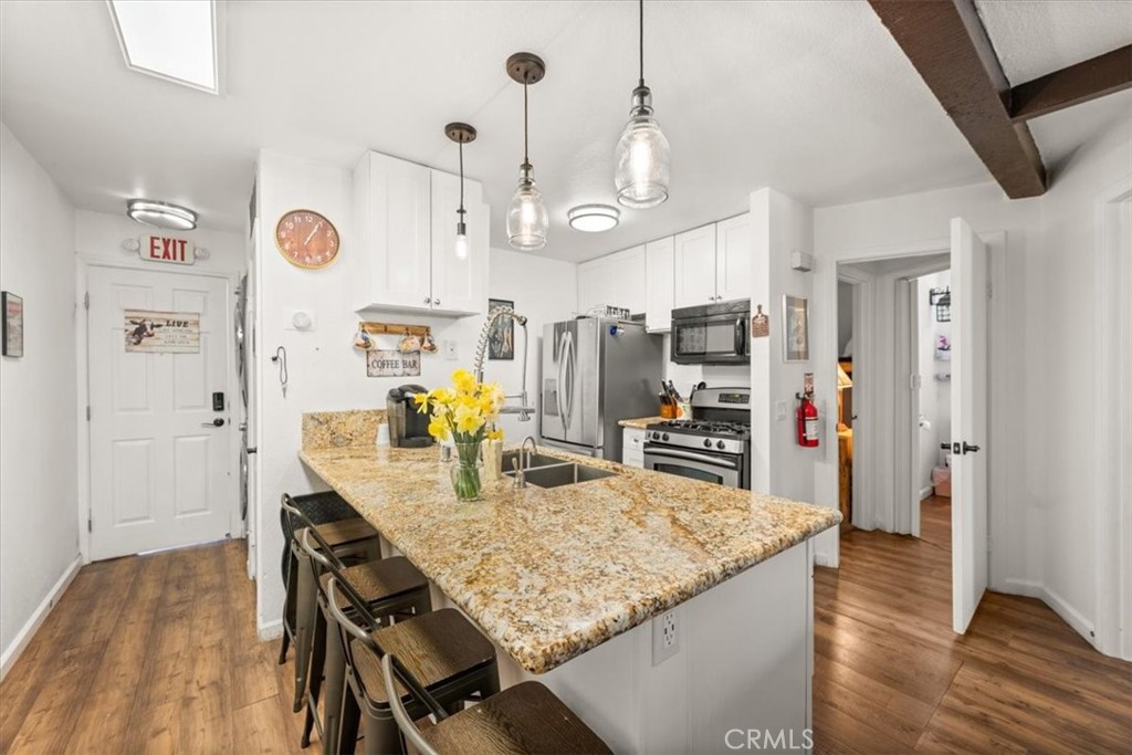 760 Bluejay Road, Unit 1 Big Bear Lake, CA 92315 - Photo 7 of 29 a kitchen with stainless steel appliances granite countertop sink and refrigerator