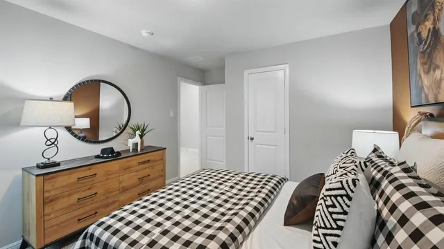 a bedroom with a large bed and a window