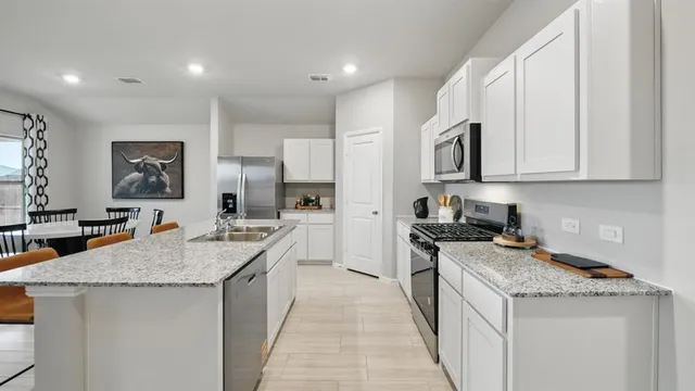 a kitchen with a sink cabinets and wooden floor