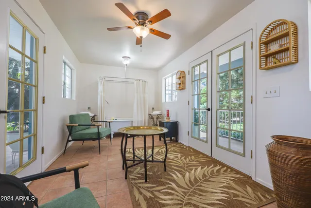 a living room with furniture a rug and a chandelier
