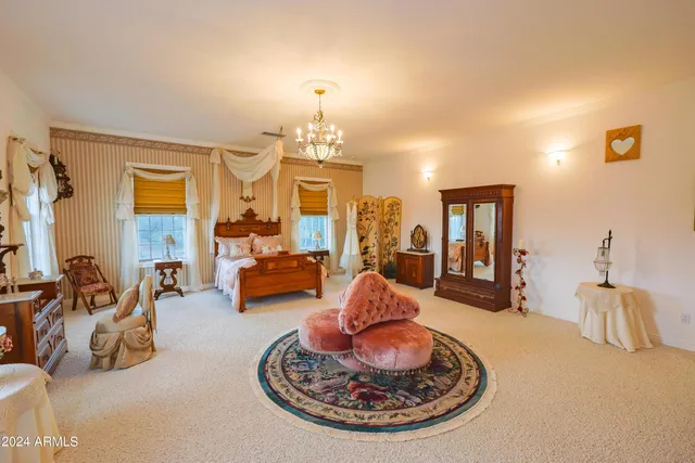 a view of a dining room with furniture and a chandelier