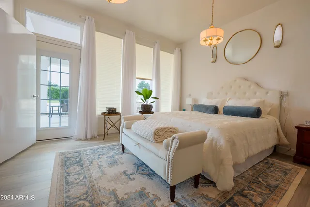a living room with furniture kitchen view and a window
