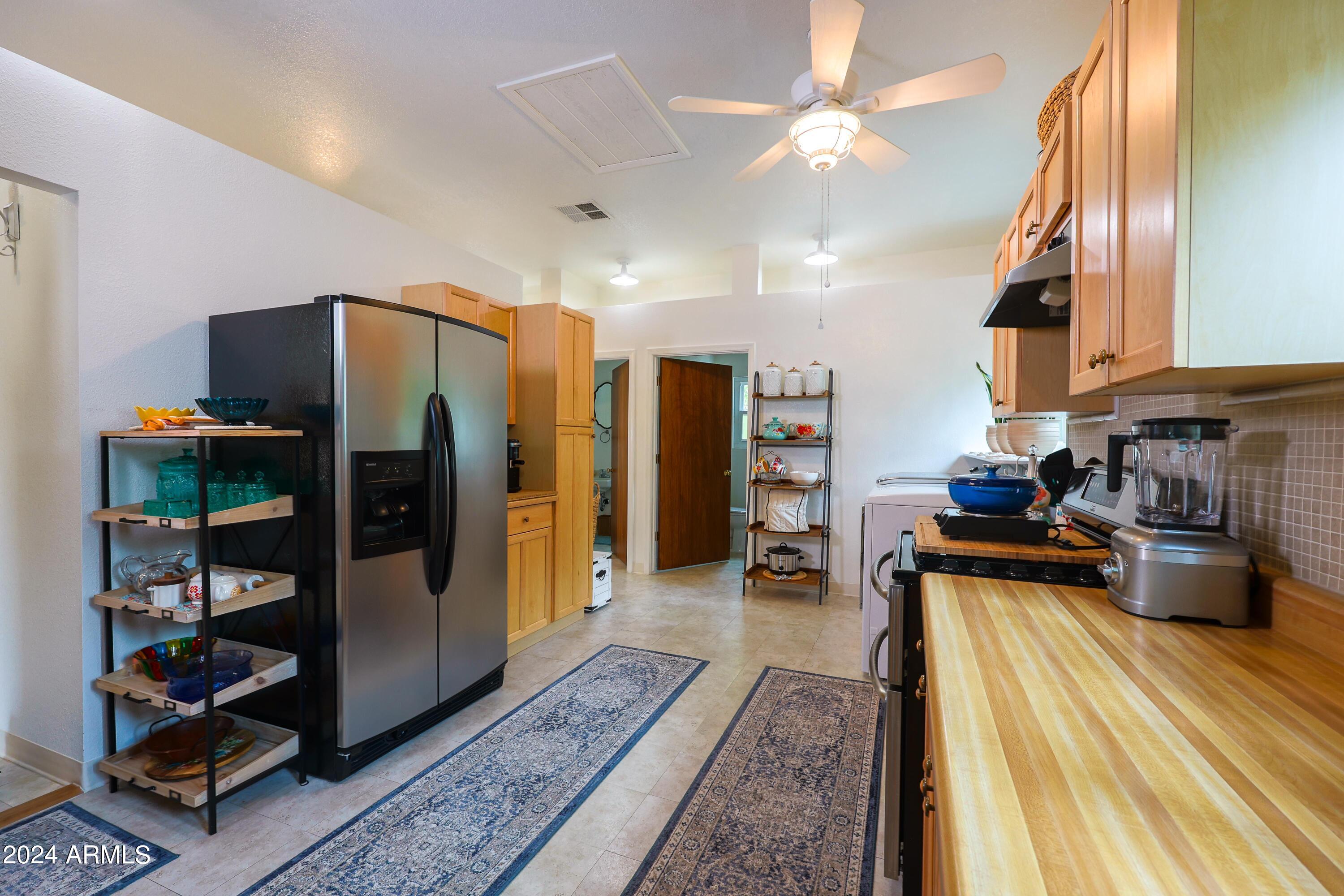 2204 North Maple Avenue Huachuca City, AZ 85616 - Photo 55 of 65 a kitchen with stainless steel appliances granite countertop a refrigerator and a sink