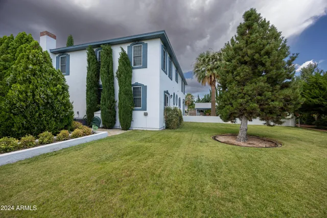 a backyard of a house with barbeque oven table and chairs