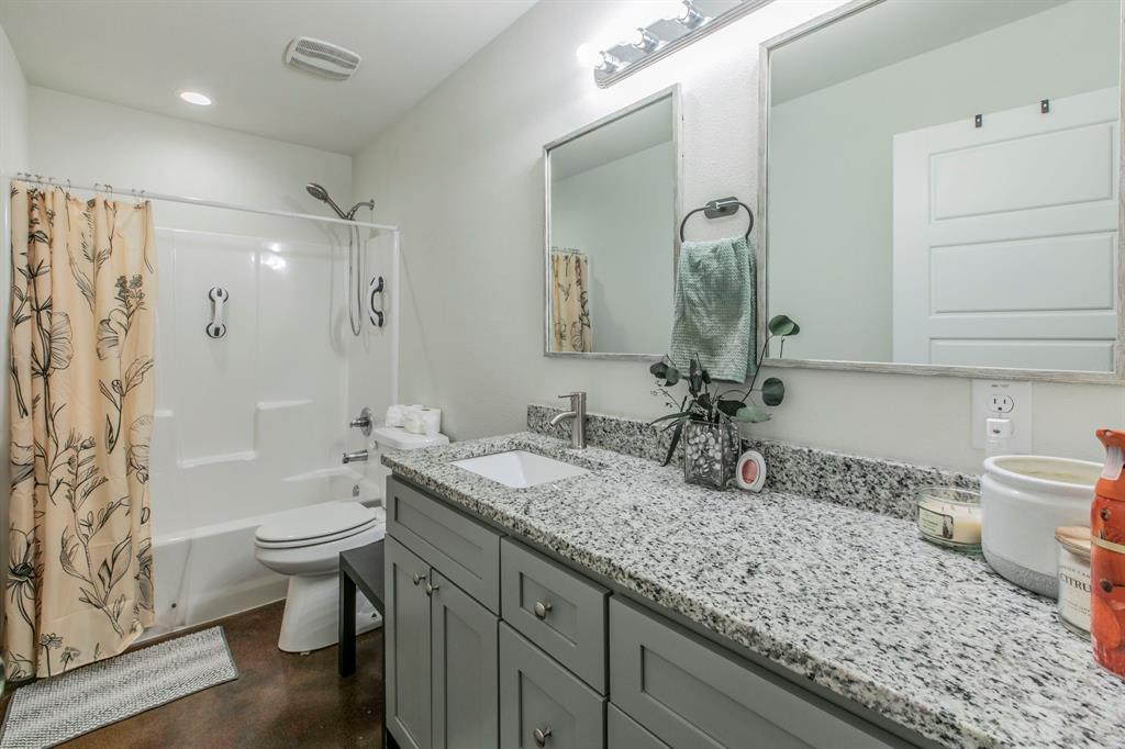 625 Delano Street Waco, TX 76704 - Photo 13 of 18 a bathroom with a granite countertop sink toilet and shower