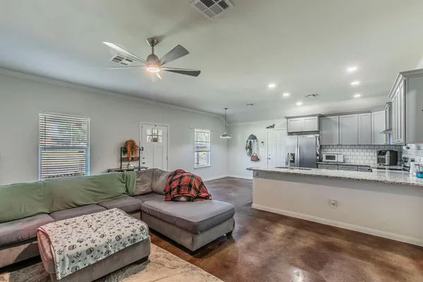 a living room with furniture and a chandelier
