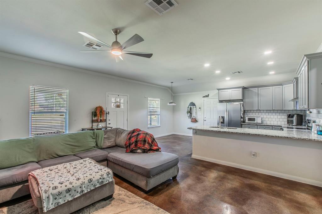 625 Delano Street Waco, TX 76704 - Photo 3 of 18 a living room with furniture and a chandelier