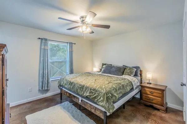a bed sitting in a bedroom next to a window