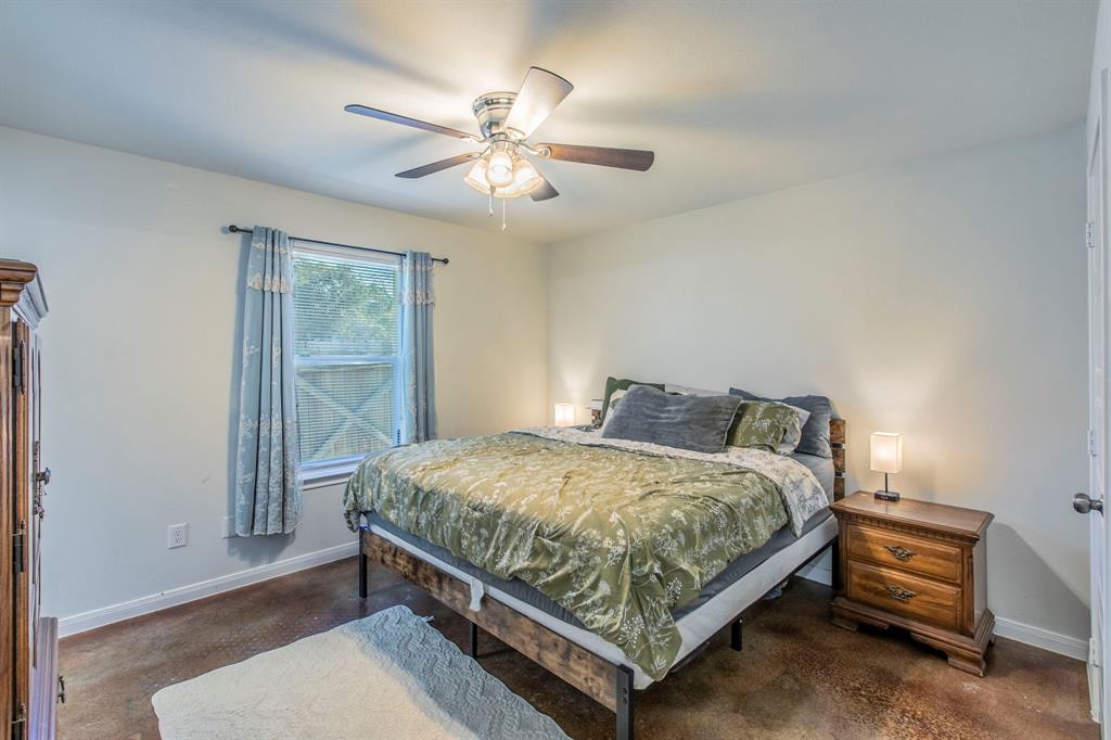 625 Delano Street Waco, TX 76704 - Photo 8 of 18 a bed sitting in a bedroom next to a window