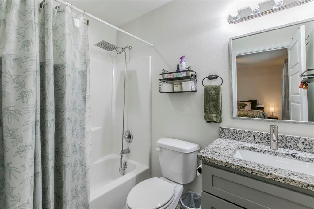 625 Delano Street Waco, TX 76704 - Photo 10 of 18 a bathroom with a granite countertop sink toilet and shower
