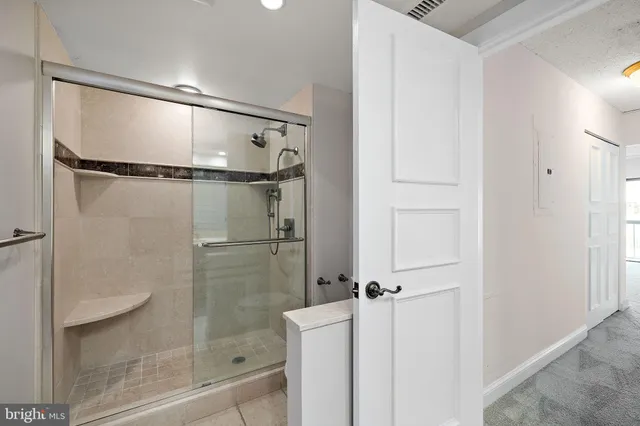 a bathroom with a glass shower door