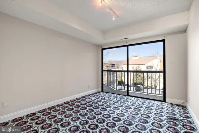 a bedroom with a bed and a lamp next to a window