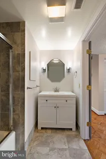 a spacious bathroom with a sink and a mirror