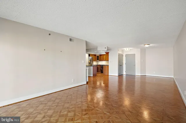 a view of empty room with wooden floor