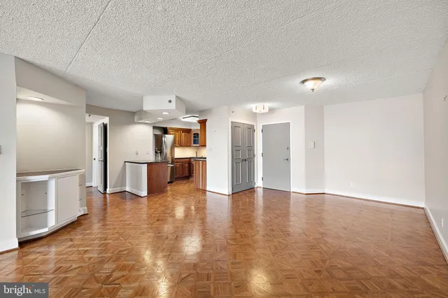a view of a kitchen with a refrigerator and a stove top oven