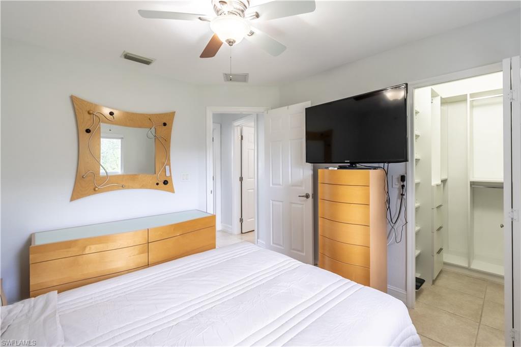 2100 55th Street Southwest Naples, FL 34116 - Photo 42 of 50 a bedroom with a bed and a flat screen tv