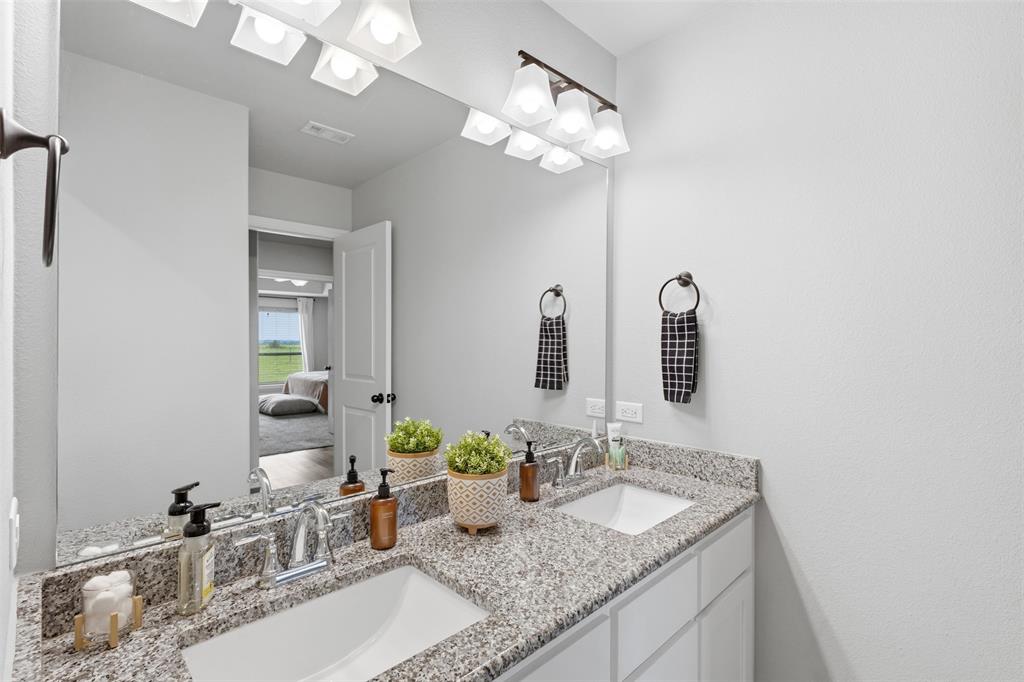 2990 Wilson Road Palmer, TX 75152 - Photo 21 of 40 a bathroom with a granite countertop sink and a mirror