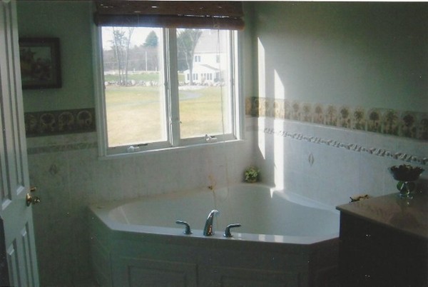 216 Rangeway Road, Unit 144 Billerica, MA 01862 - Photo 17 of 25 a bath tub sitting in a bathroom next to a window