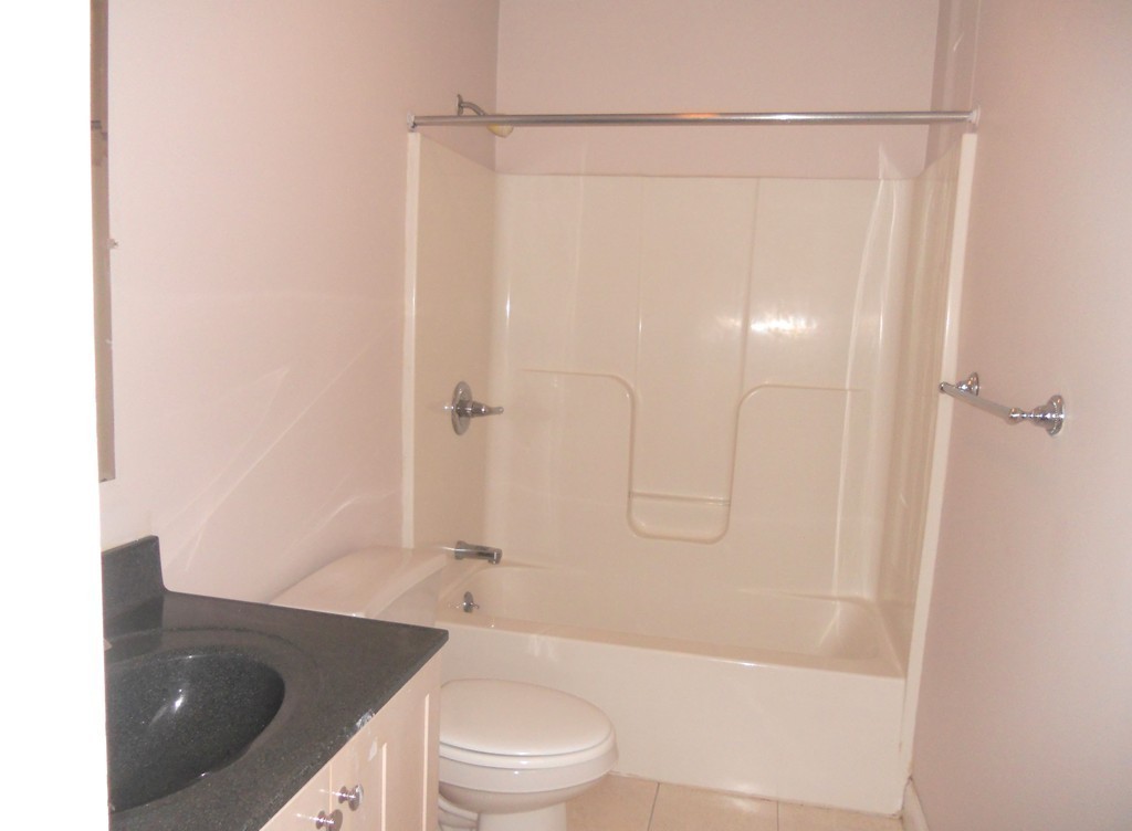 216 Rangeway Road, Unit 144 Billerica, MA 01862 - Photo 23 of 25 a bathroom with a granite countertop bathtub shower sink vanity and toilet