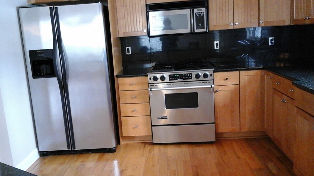 216 Rangeway Road, Unit 144 Billerica, MA 01862 - Photo 5 of 25 a kitchen with a refrigerator and a stove