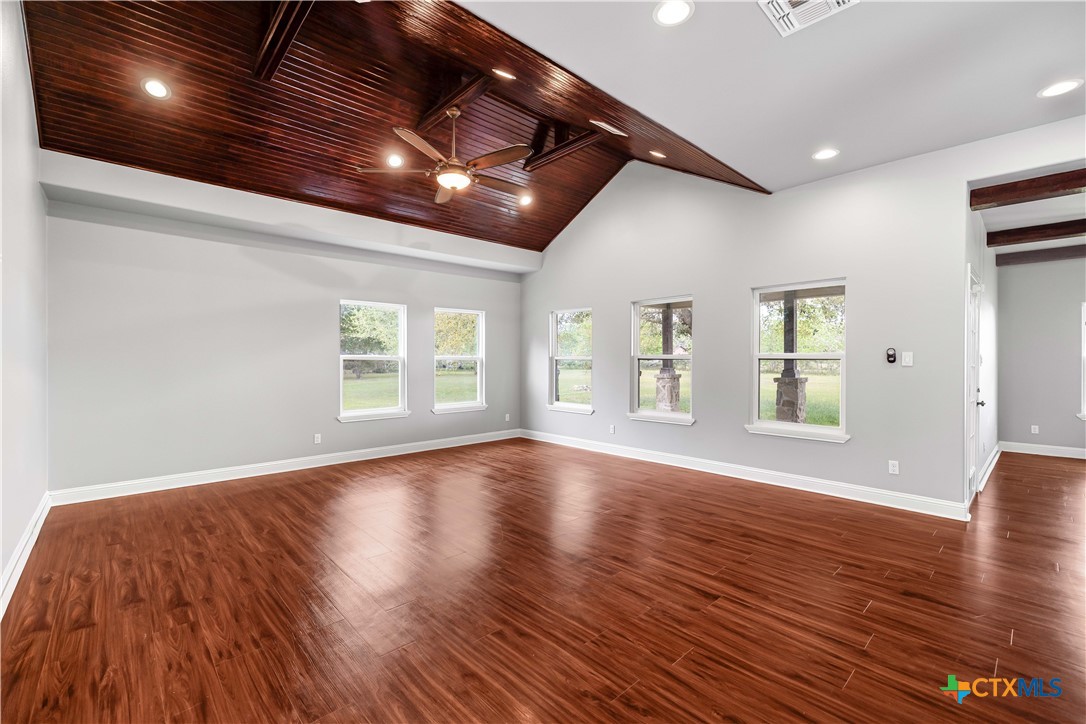 204 James Street Inez, TX 77968 - Photo 6 of 35 a view of an empty room with wooden floor and windows