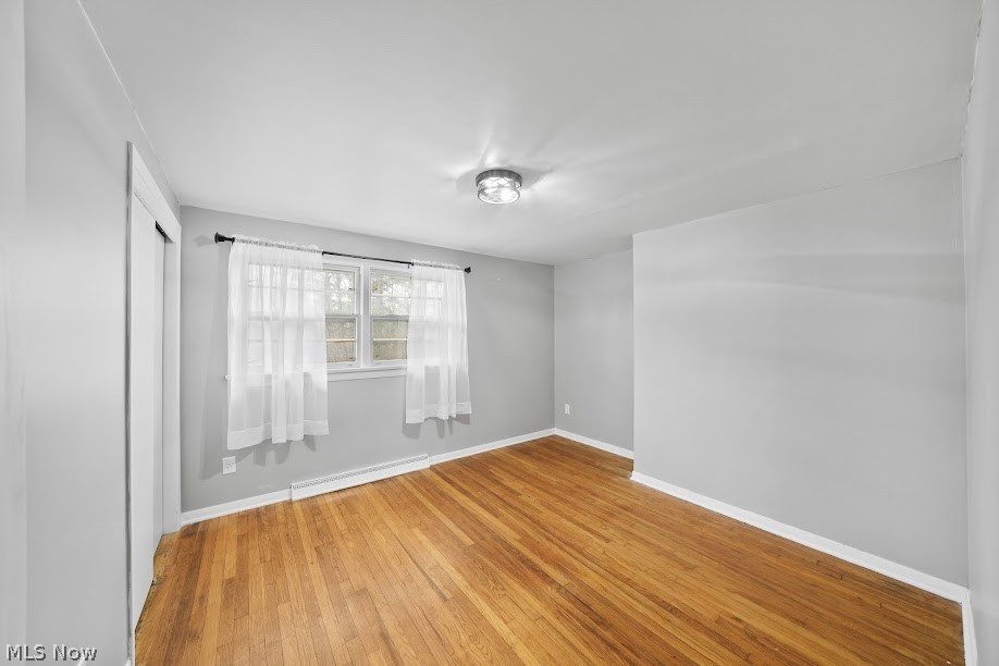 3235 Chapel Road Ashtabula, OH 44004 - Photo 5 of 13 Empty room with light wood-type flooring and a baseboard radiator