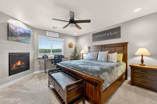 a bedroom with bed and a fireplace