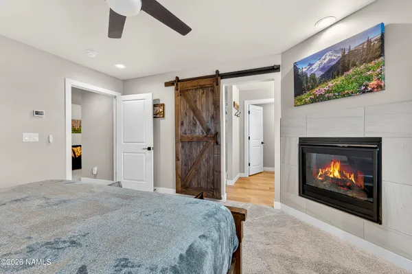 a bedroom with furniture and a fireplace