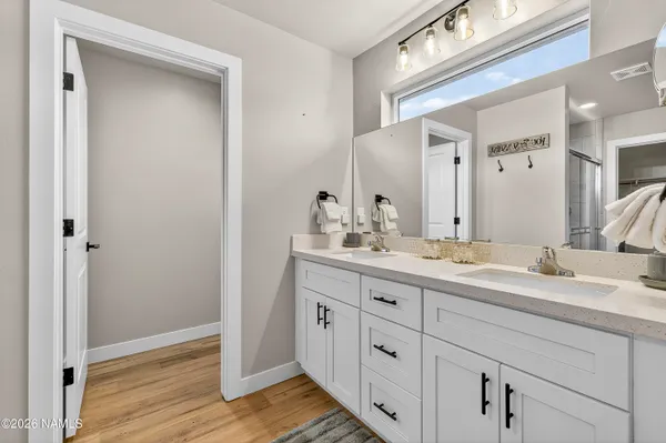 a bathroom with a double vanity sink and mirror