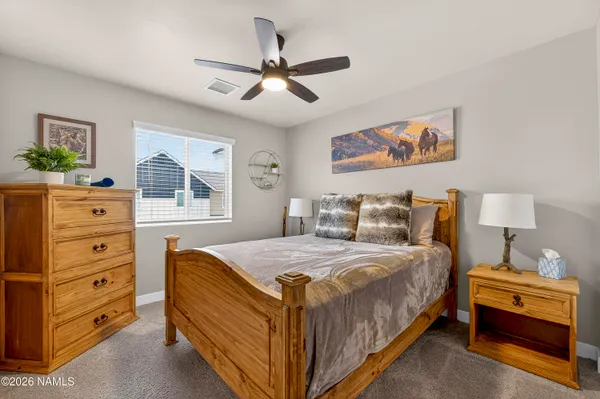 a bedroom with a bed and a dresser